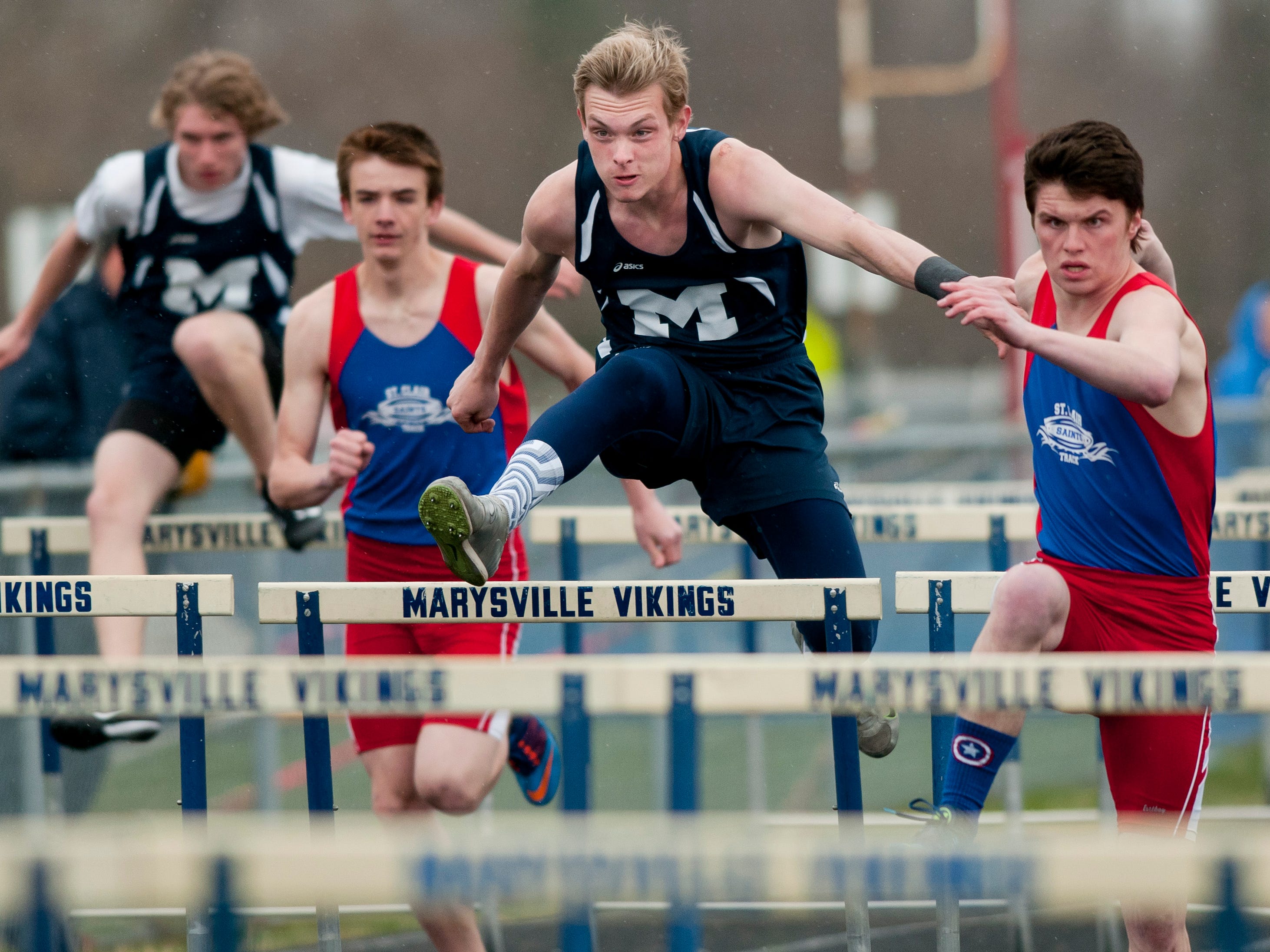 Marysville junior Mike Rasnick and St. Clair senior Nathan Roberts compete in the hurdles during a track meet Thursday, April 30, 2015 at Marysville High School.