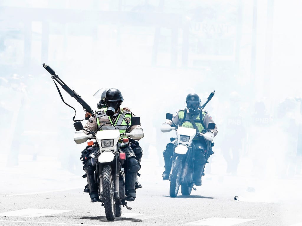Policemen clash with opposition demonstrators in Caracas. Venezuela's President Nicolas Maduro formally launched moves to rewrite the constitution  defying opponents who accuse him of clinging to power in a political crisis that has prompted deadly u
