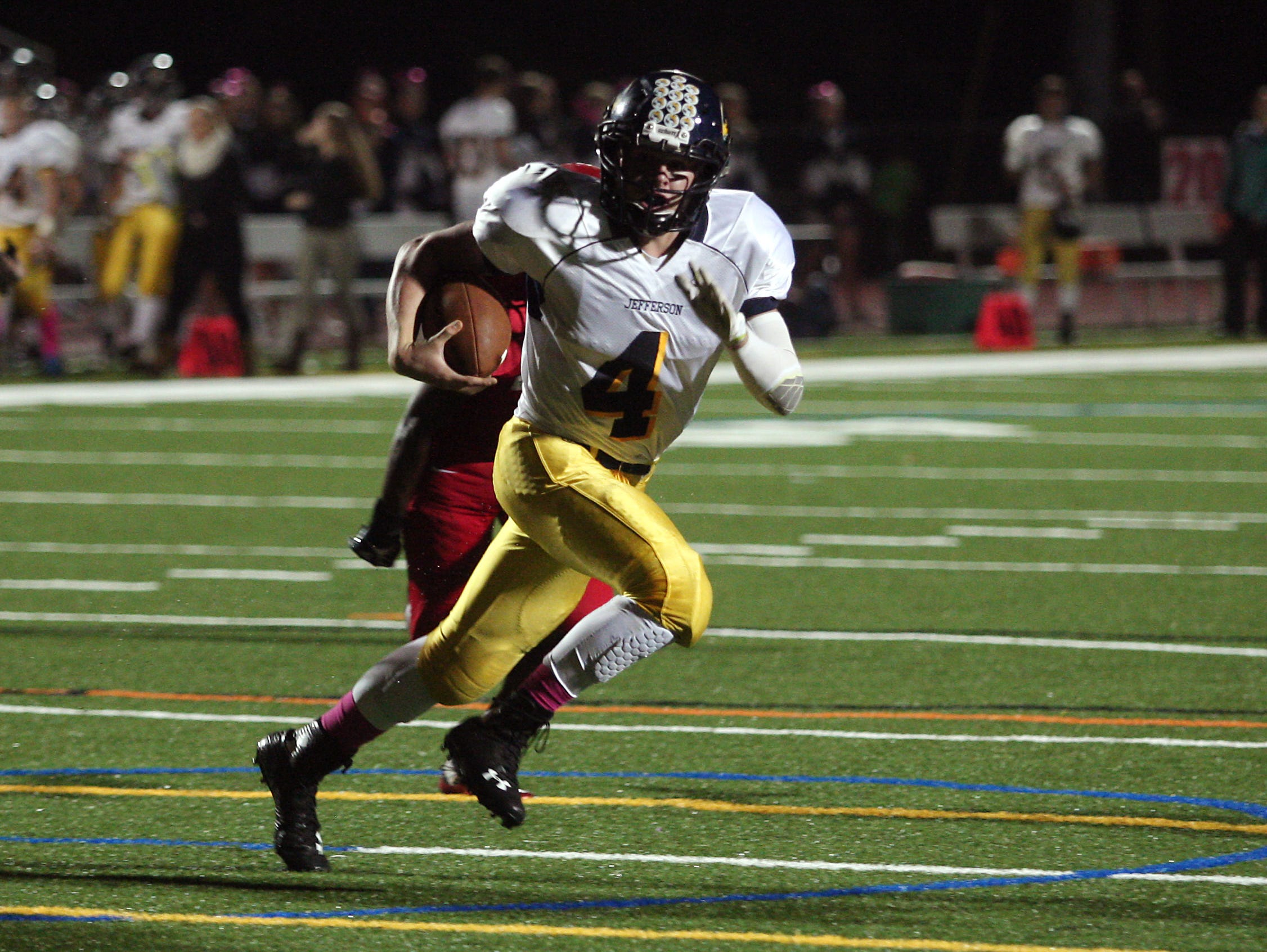 Jefferson quarterback Logan Holleritter on a keeper vs Parsippany in a Friday night football matchup. October 9, 2015, Parsippany, NJ.
