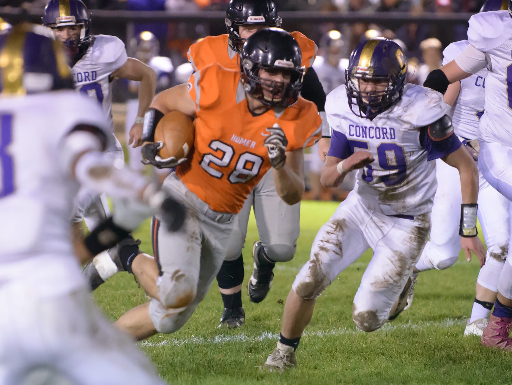Homer RB Hunter Wilson (28) rushes for positive yards Friday night.