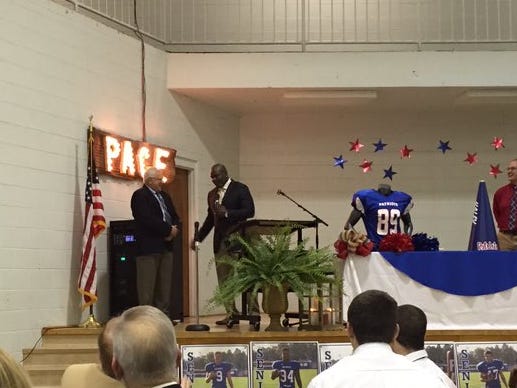 Former Pace High School football coach Mickey Lindsey, left, honored by NFL Hall of Famer and Escambia grad Emmitt SMith on Sunday.