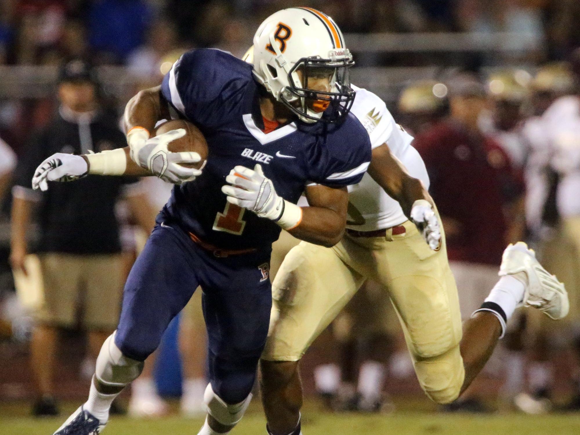 Blackman’s Amauri Burks runs the ball as he is tackled by Riverdale’s Jarek Campbell on Friday.