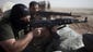 Kurdish Peshmerga fighters hold a position during a battle against Islamic State militants on Sept. 11 at Yangije, Iraq.