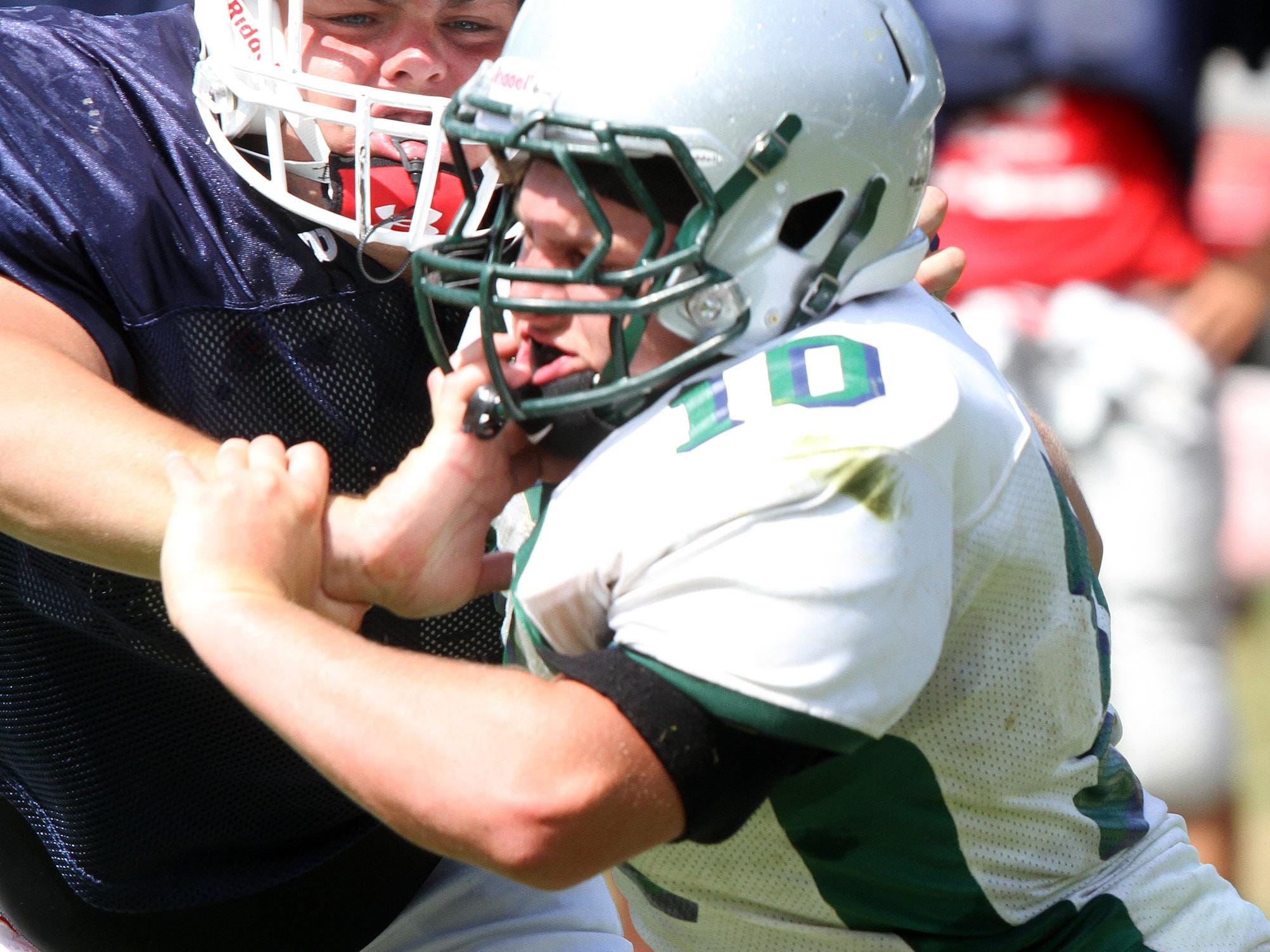 Manalapan offensive lineman Joe Sellmeyer (left) blocks Colts Neck’s Joe Giacalone during a scrimmage Aug. 27.