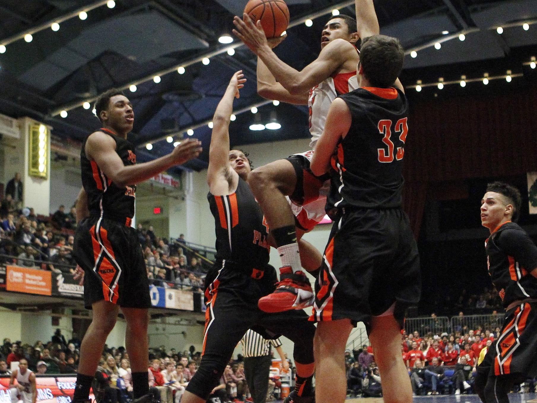 Fox Lane's Alex Olson (23) drives through White Plains' Matt Scott (4) and Spencer Lodes (33) during the boys Class AA semi-final basketball game at the County Center in White Plains on Friday, February 26, 2016.