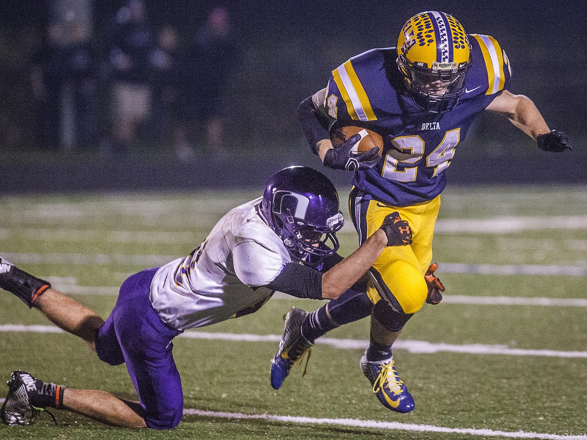 Delta’s Zach Mills, right, tries to get past a Northwestern defensive player during a 2014 sectional game.