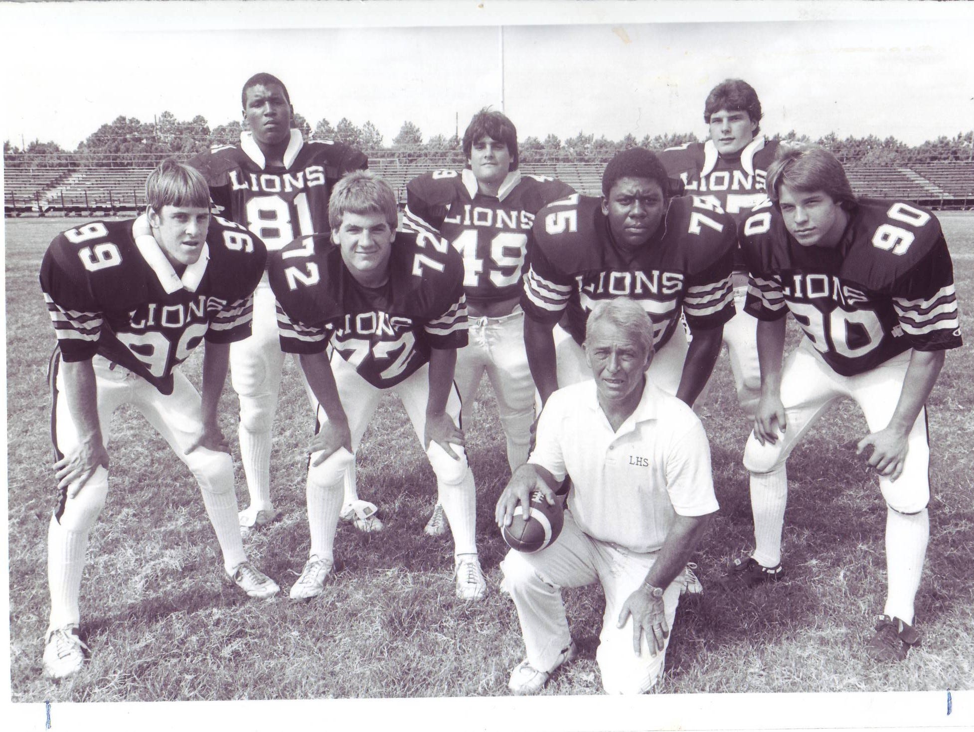 Former Lafayette High assistant coach Frank Barousse with his Mighty Lion defensive front in the early 1980s, led by standout linebackers Cedric Figaro, back left, and Randy Guidry, back right.