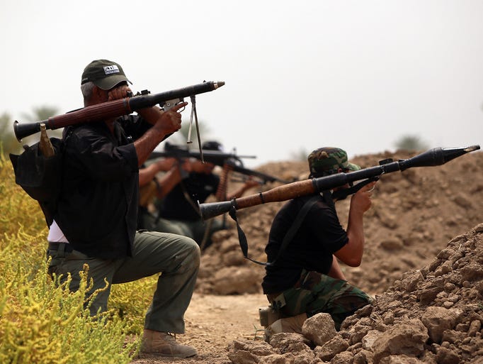 Shiite fighters back the Iraqi army during a battle against militants in the Jurf al-Sakher district.