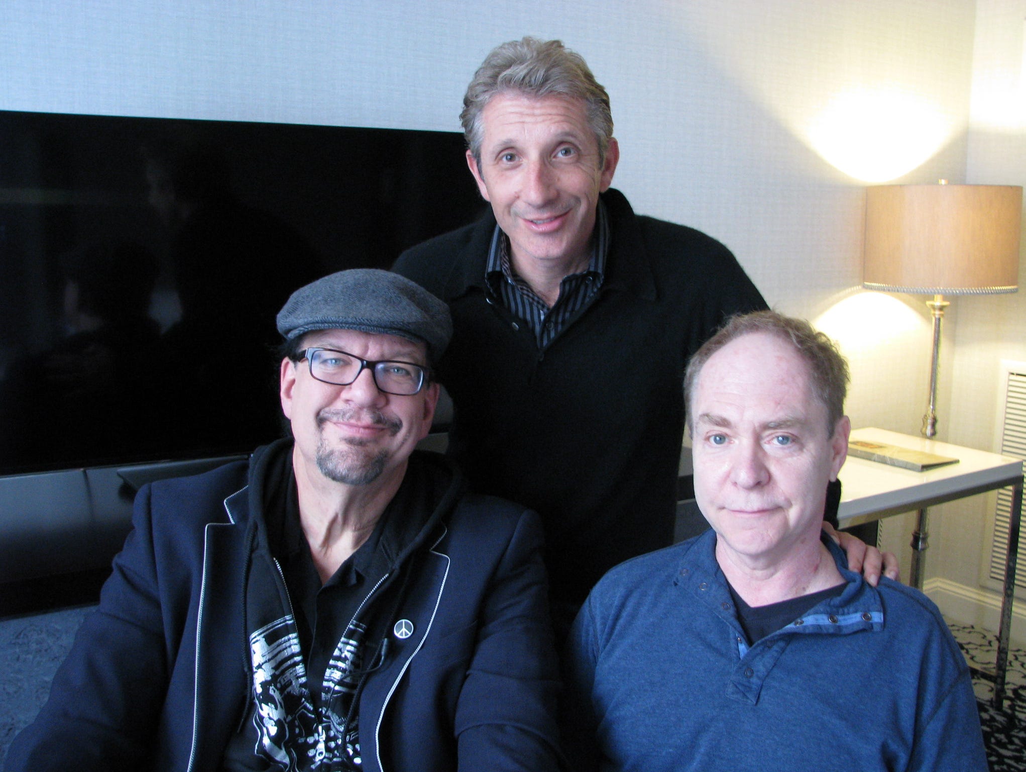 Magicians Penn Jillette (left) and his partner Teller (right) with reporter Marco della Cava (center). Penn & Teller were in San Francisco Tuesday Feb. 3, 2015 to be honored at a comedy festival.