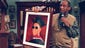 Bill Cosby holds up a portrait of Ennis before the