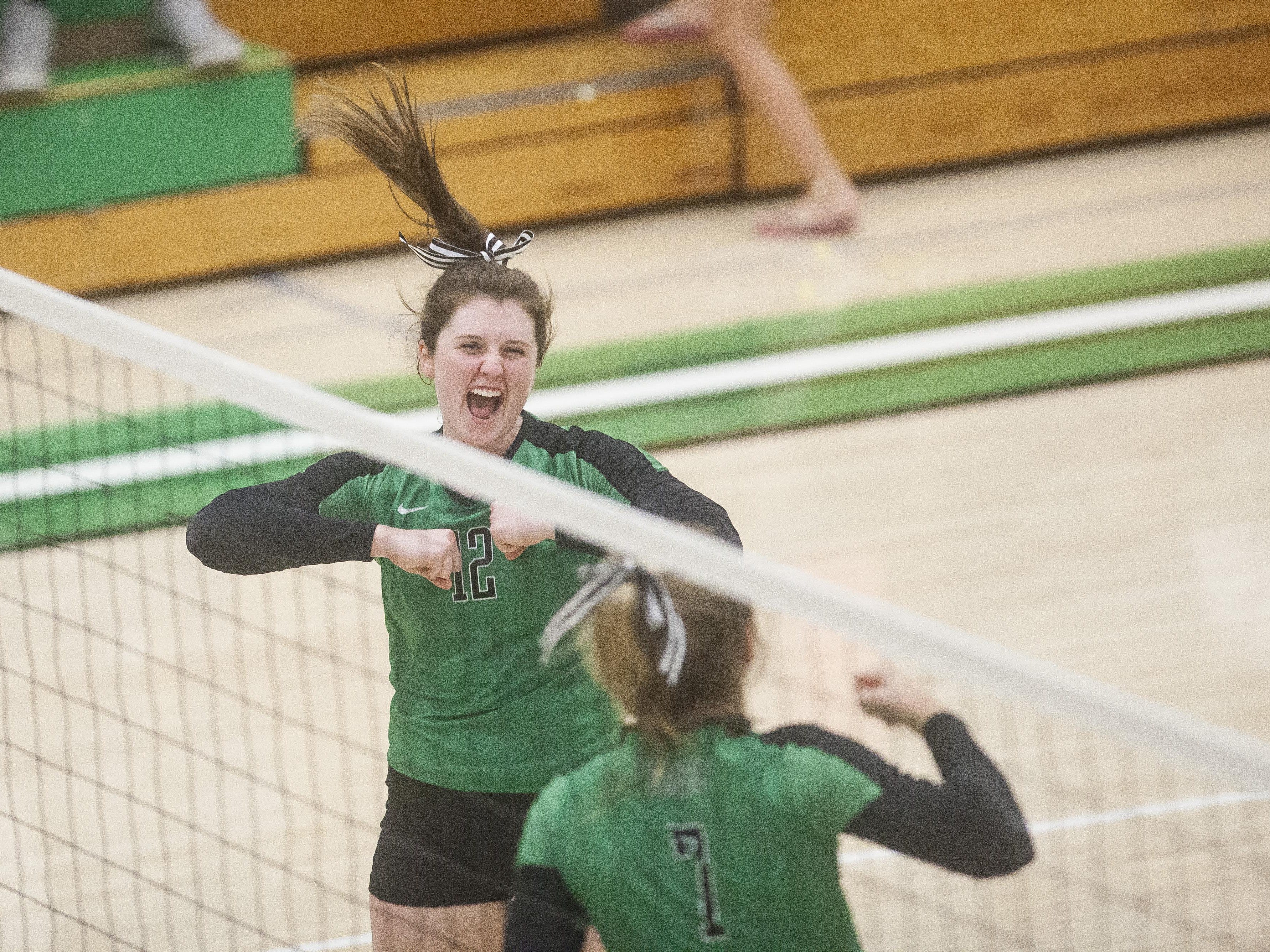 Mimi Arrington and Olivia Reed celebrate a Yorktown kill Monday evening during their match against Wapahani. The Tigers swept the Raiders.