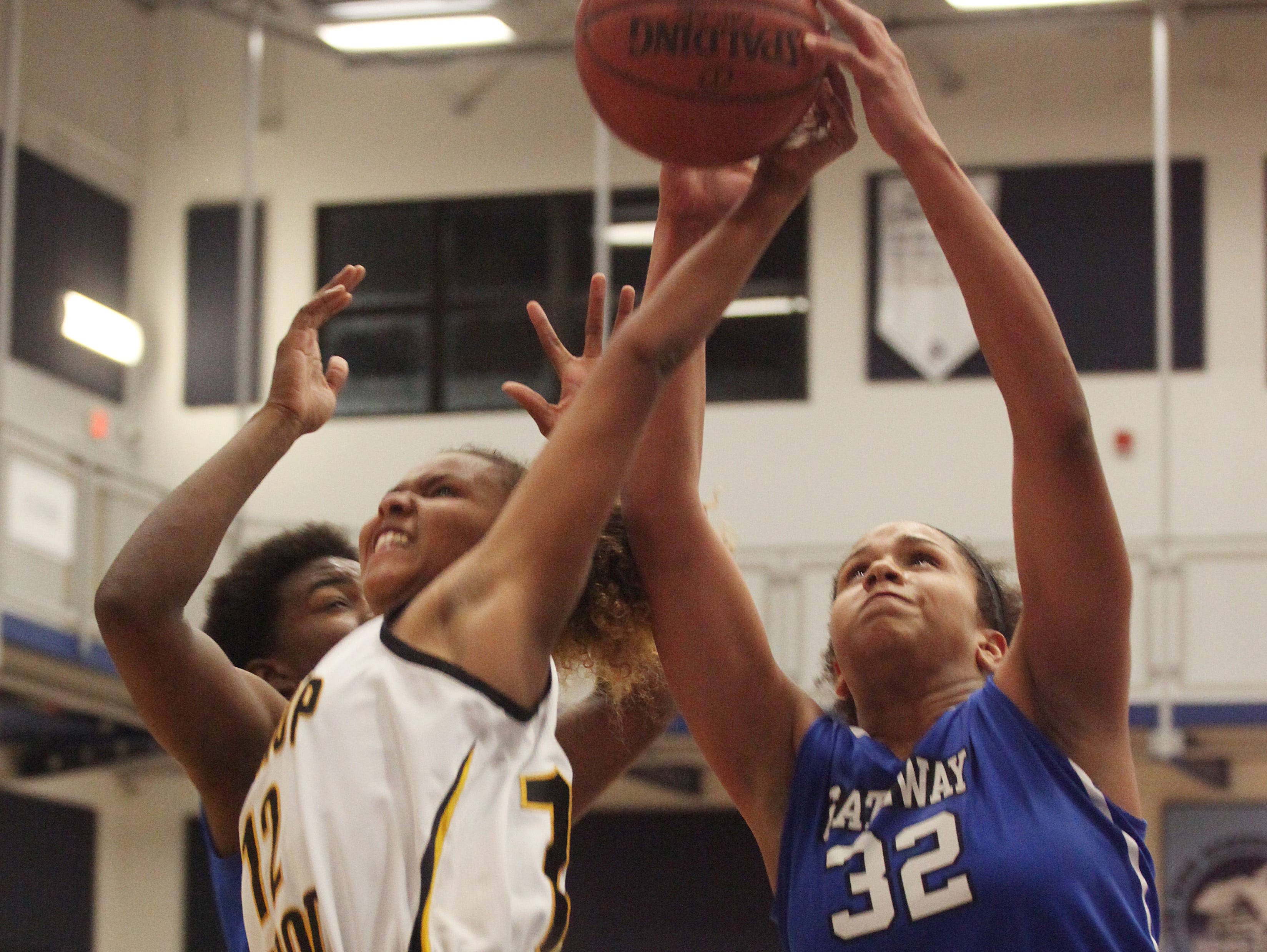Gateway Charter’s Tamia Battle and Bishop Verot’s Sequoyah Robinson battle over the rebound during the District 4A-10 finals at Oasis High School on Thursday night.
