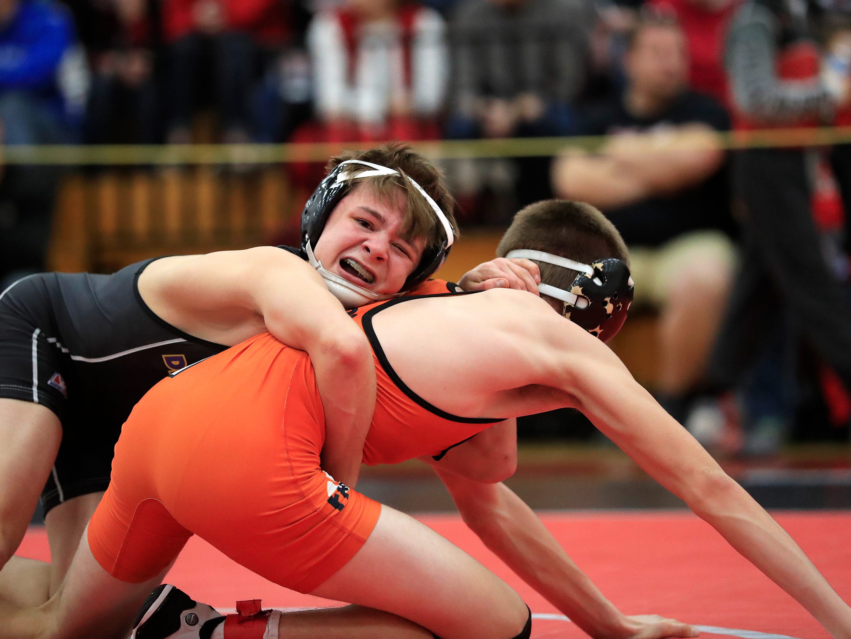 Denmark's Brock Bergelin wrestles Oconto Falls' Bryce Peterson in the 120-pound championship bout on Saturday at the Pulaski Invitational wrestling tournament. Bergelin won the match with a 13-2 decision to earn his 150th win of his high school career.