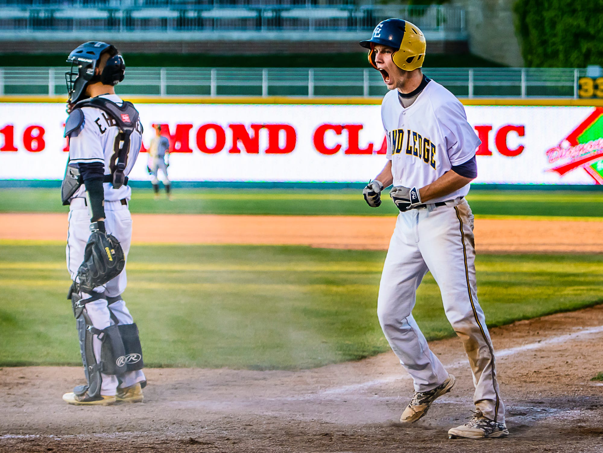 Brendan Baker of Grand Ledge celebrates after scoring to cut the Holt lead to one in the 5th inning of their Diamond Classic championship game Wednesday.