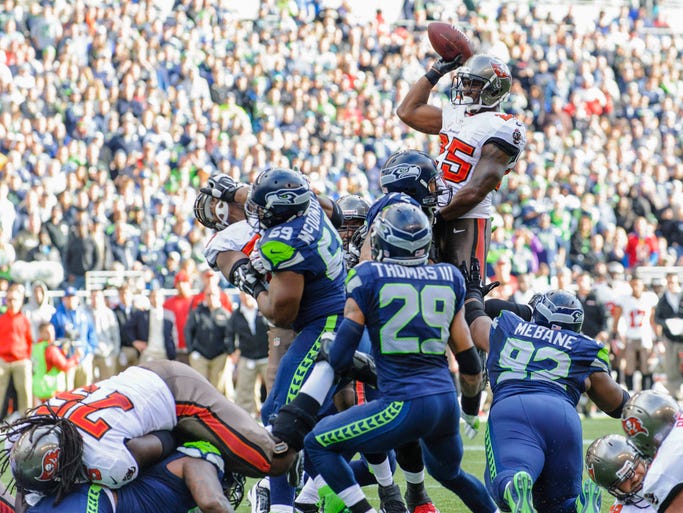 Tampa Bay Buccaneers running back Mike James (25) passes the ball to Tampa Bay Buccaneers tight end Tom Crabtree (84) (not pictured) for a touchdown against the Seattle Seahawks during the first half at CenturyLink Field.