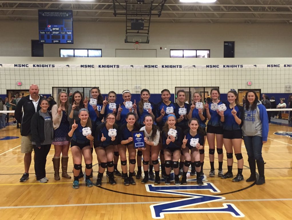 The Millbrook High School volleyball team poses with the Section 9 Class C plaque.