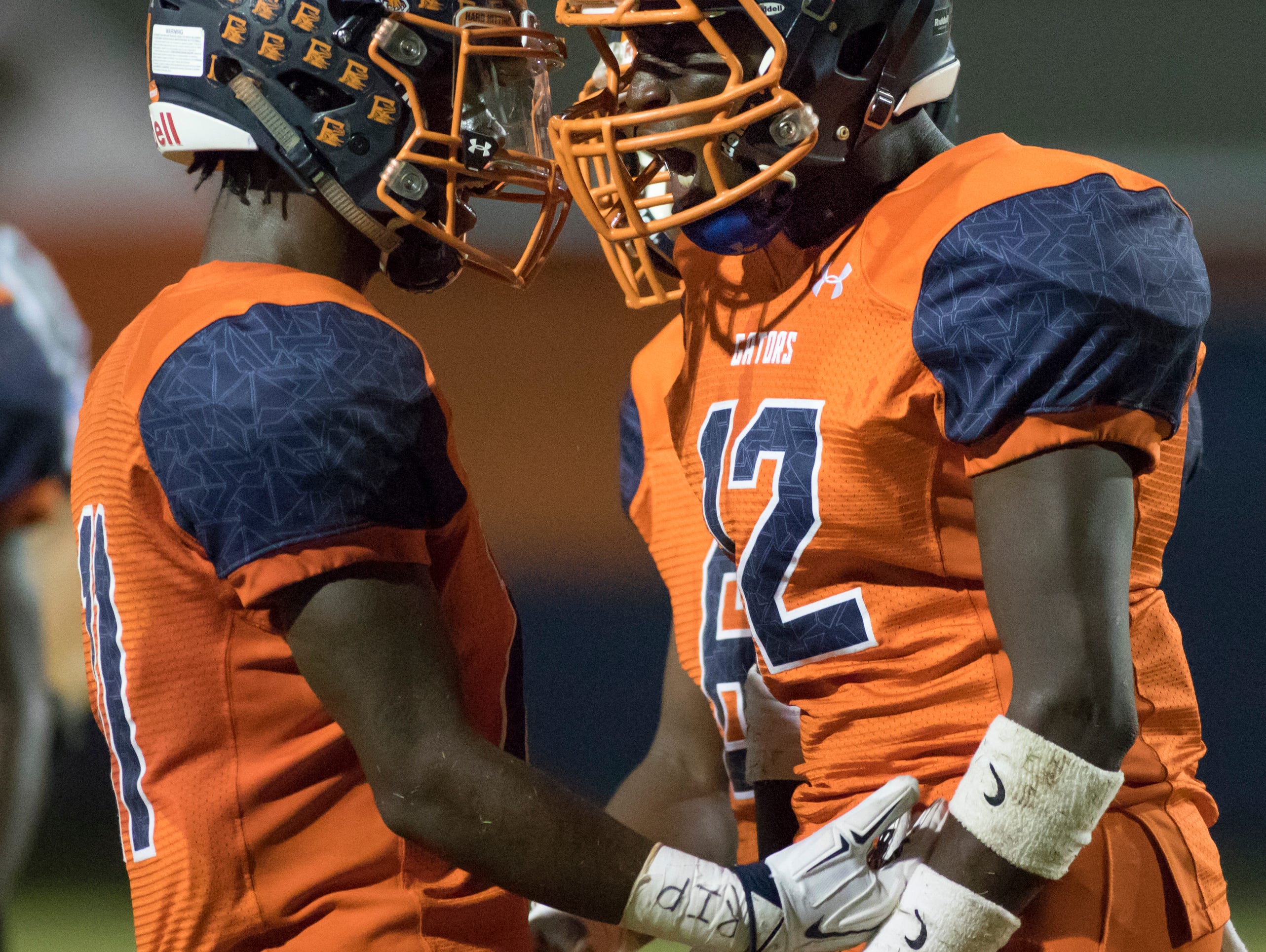 Martin McGhee (11) and Tre Lewis (12) get excited after scoring during the Pine Forest v Escambia football game on Friday, September 30, 2016.