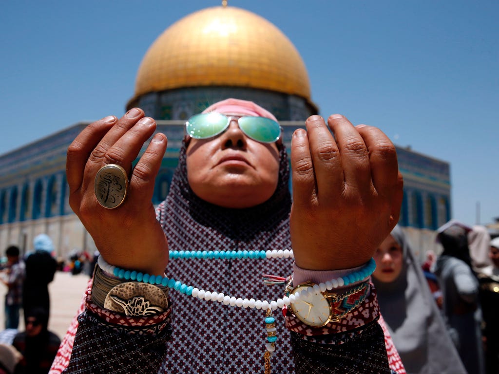 A Palestinian Muslim worshipper attends the second Friday prayers of the Muslim holy month of Ramadan in front of the Dome of the Rock at Jerusalem's al-Aqsa mosque compound.
