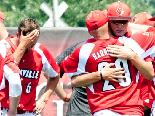 As Louisville Cardinals'  Chandler Dale holds his head,