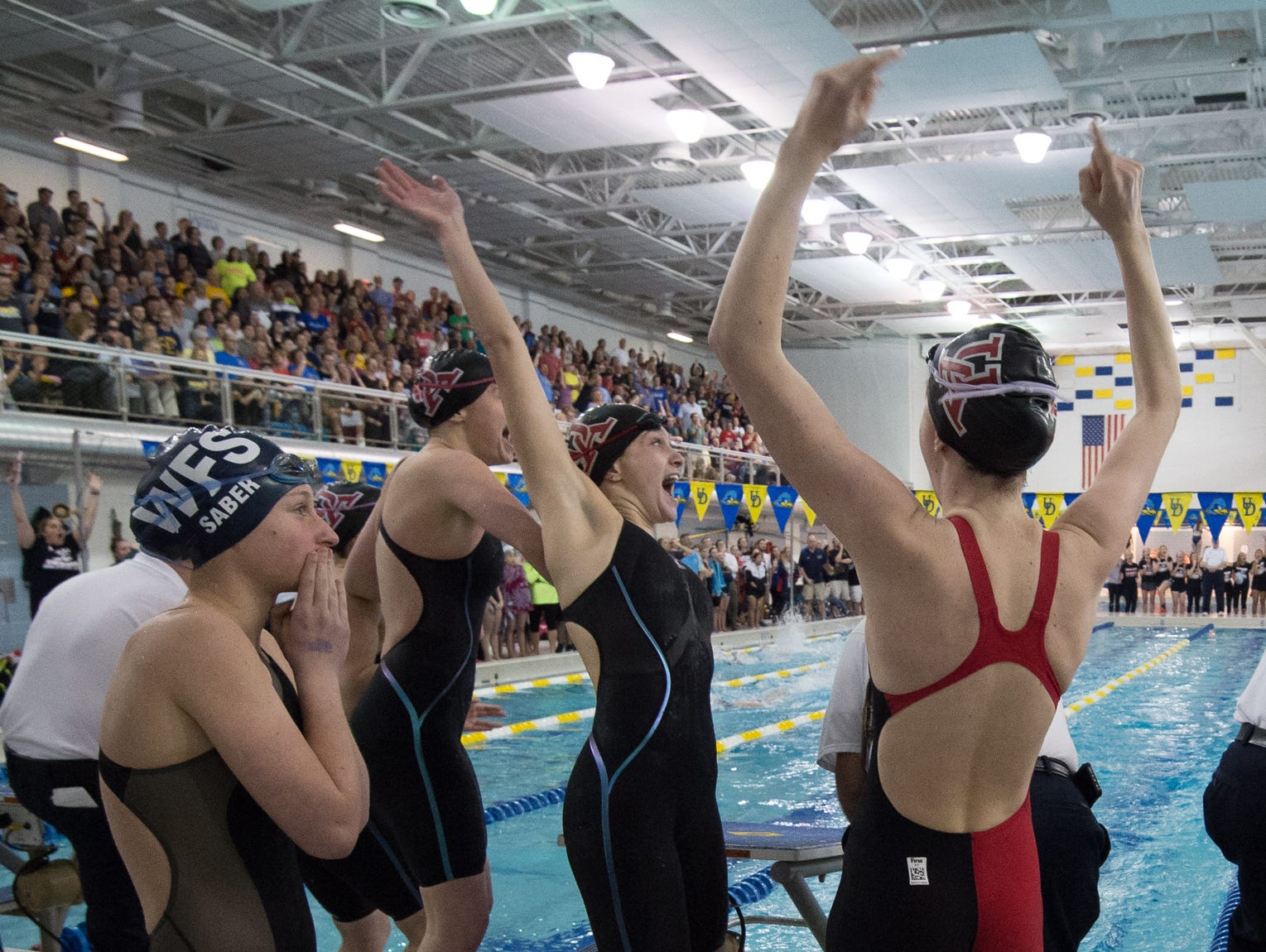 Swimmers from Ursuline Academy celebrate after winning the 200 yard medley relay at the girl's DIAA swimming and diving championships at the University of Delaware.