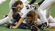 Ken Griffey Jr. smiles from beneath a pile of teammates