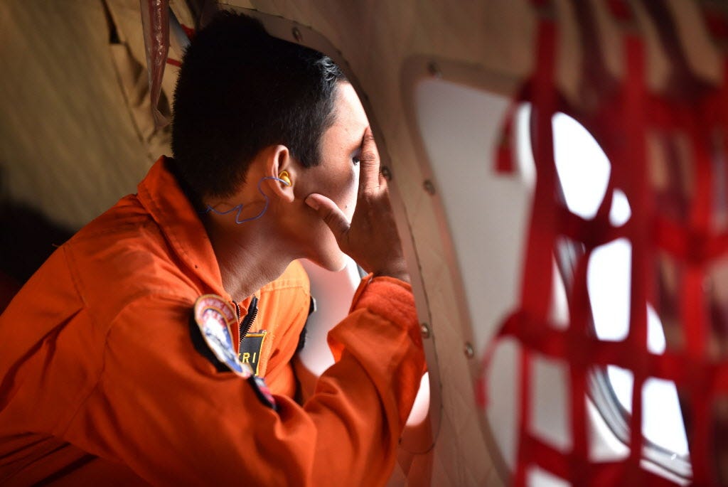 Families pray as search continues for AirAsia victims