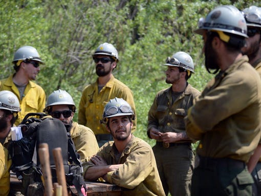 Members of the Arroyo Grand Hotshots crew await transport