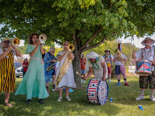 Members of the Scottville Clown Band warm up while