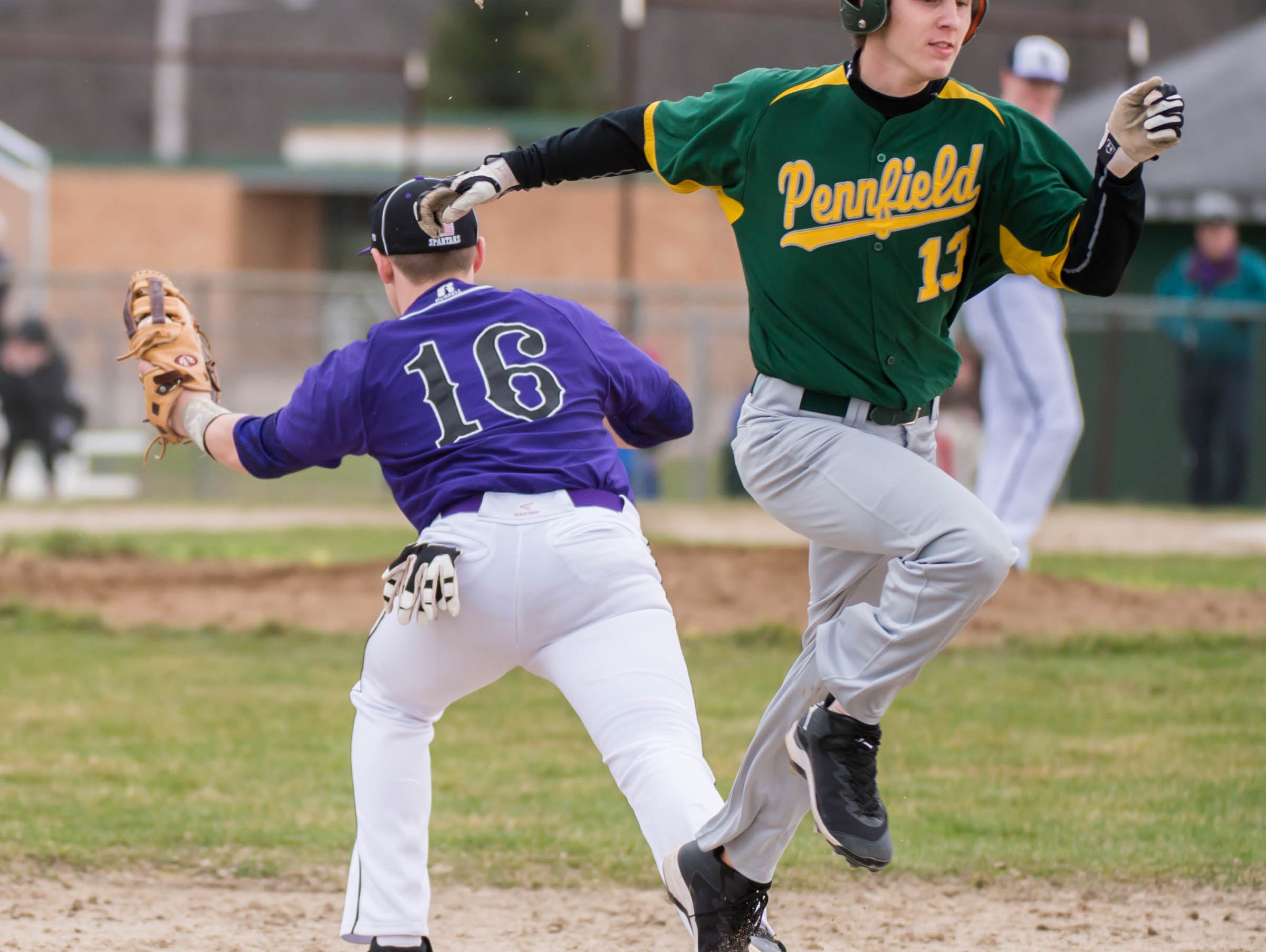 Lakeview's Kevin Sprick (16) gets Pennfield's Jeremy Cook (13) out at first base during a recent game.