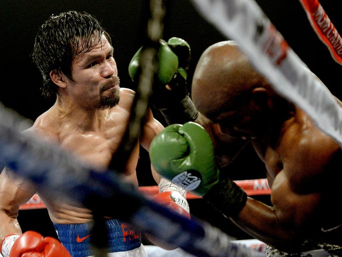 Timothy Bradley Jr. (green gloves) and Manny Pacquiao (red gloves) during their WBO World Welterweight Championship fight at MGM Grand Garden Arena.