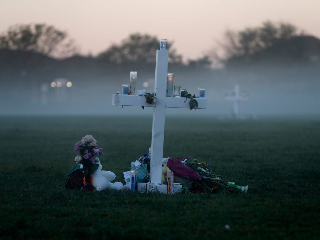An early morning fog rises where 17 memorial crosses were placed, for the 17 deceased students and faculty from the Wednesday shooting at Marjory Stoneman Douglas High School, in Parkland, Fla., Feb. 17, 2018. As families began burying their dead, au