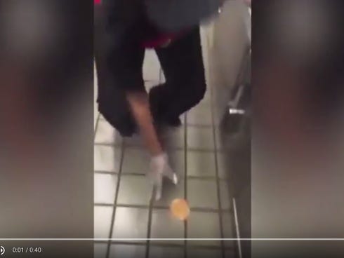 A video of Checker's employee rubbing a sandwich on the ground and preparing it as if for a customer, has gone viral.