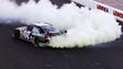 Clint Bowyer does a burnout after scoring his first career NASCAR Cup win at the Sylvania 300 at New Hampshire Motor Speedway on Sept. 16, 2007.