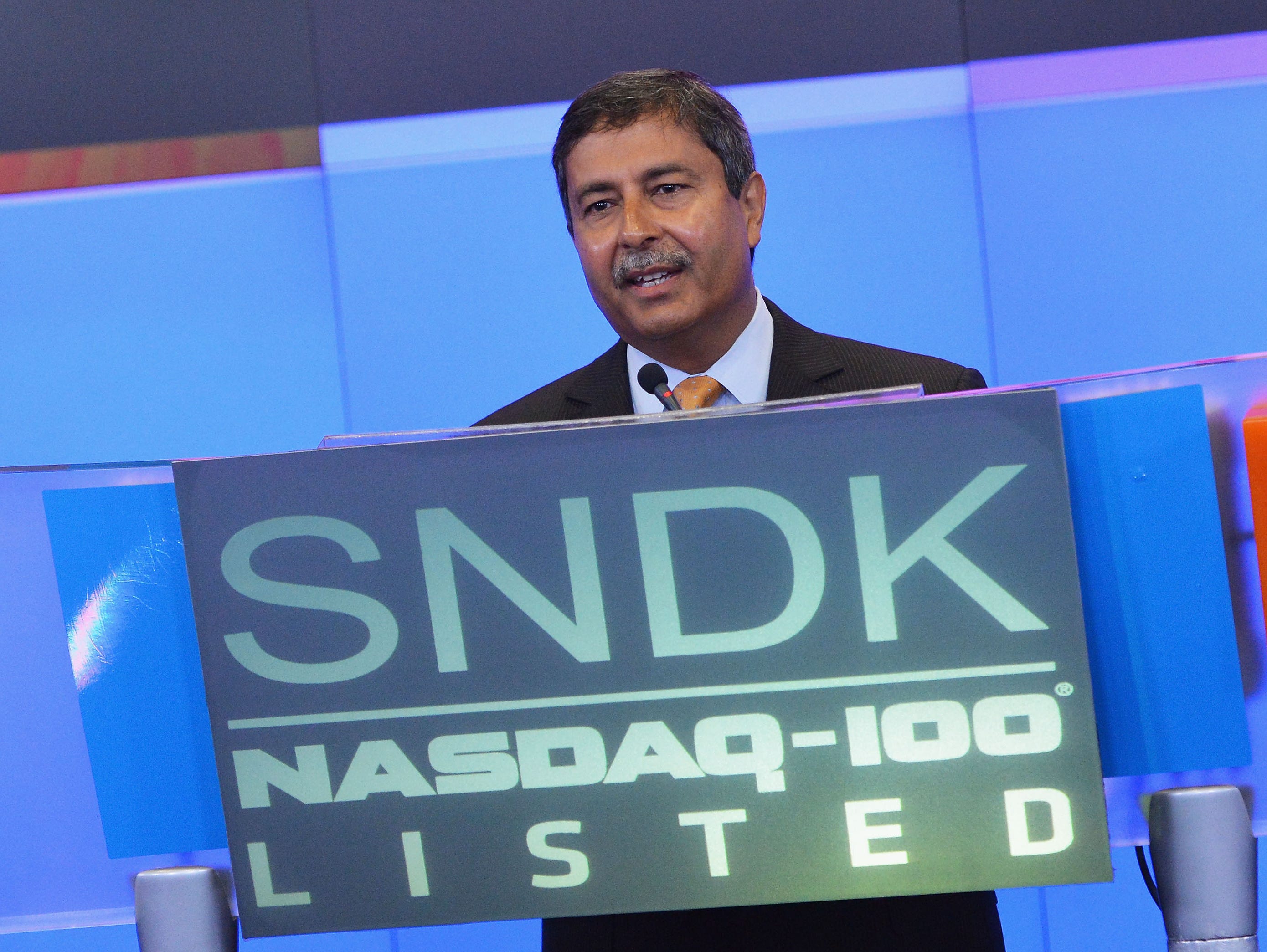 Sanjay Mehrotra, President, Chief Executive Officer and Co-Founder of SanDisk Corporation, rings the Opening Bell at the Nasdaq MarketSite in 2013.