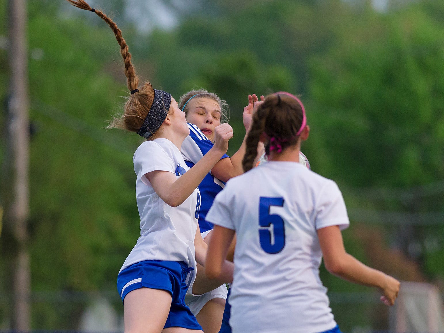 Leigh Willis (8) of Middletown and Leah Frerichs (22) of Charter collide in the air in Charter at Middletown girls soccer game on Wednesday.