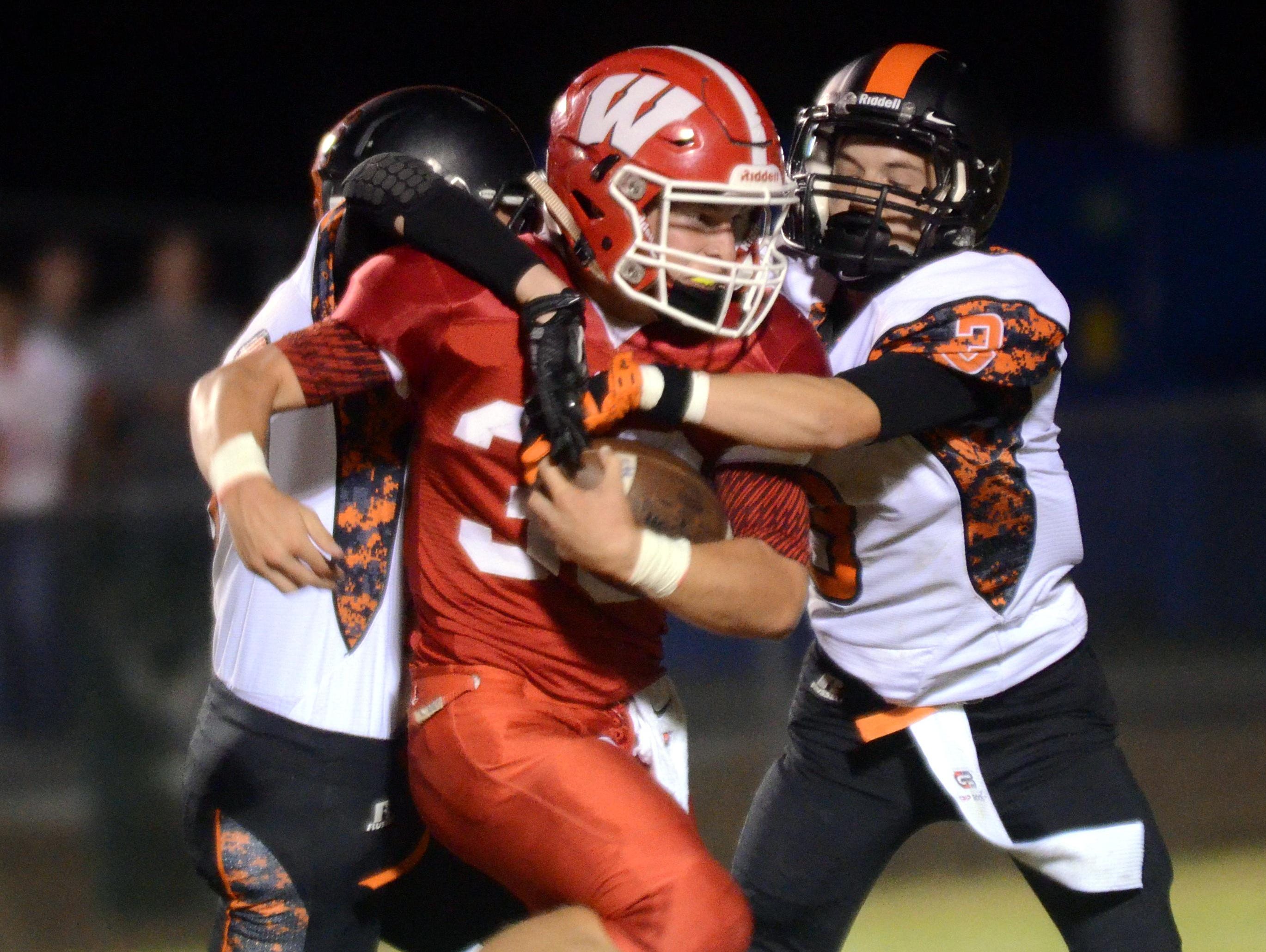Westmoreland High senior tailback Brandon Green carries the football as Cascade sophomores Brandon Floyd and Will Carter attempt to tackle Green. Green had a 51-yard touchdown reception and a 20-yard touchdown run in the Eagles’ 49-14 victory on Friday evening.