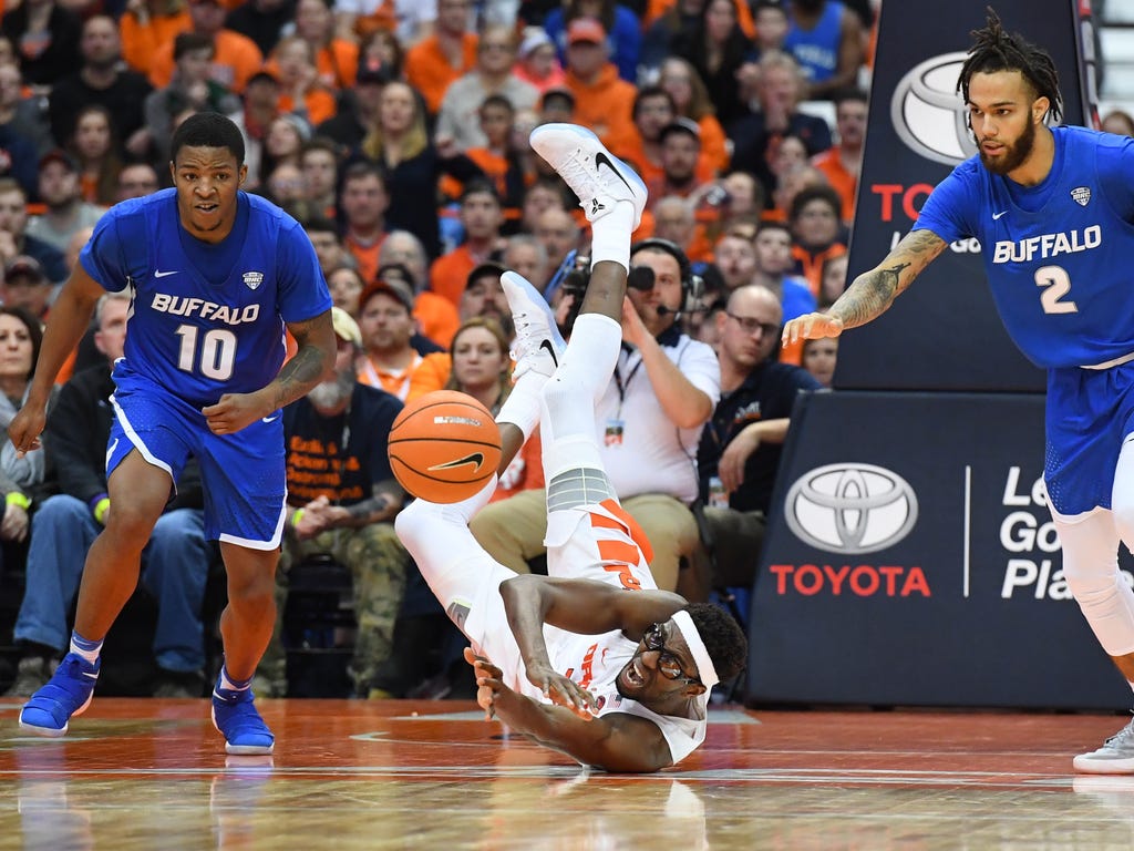 Buffalo Bulls guard Wes Clark, left, Syracuse Orange center Paschal Chukwu  and Buffalo Bulls guard Jeremy Harris, right, react to a loose ball during the second half at the Carrier Dome in Syracuse, N.Y.