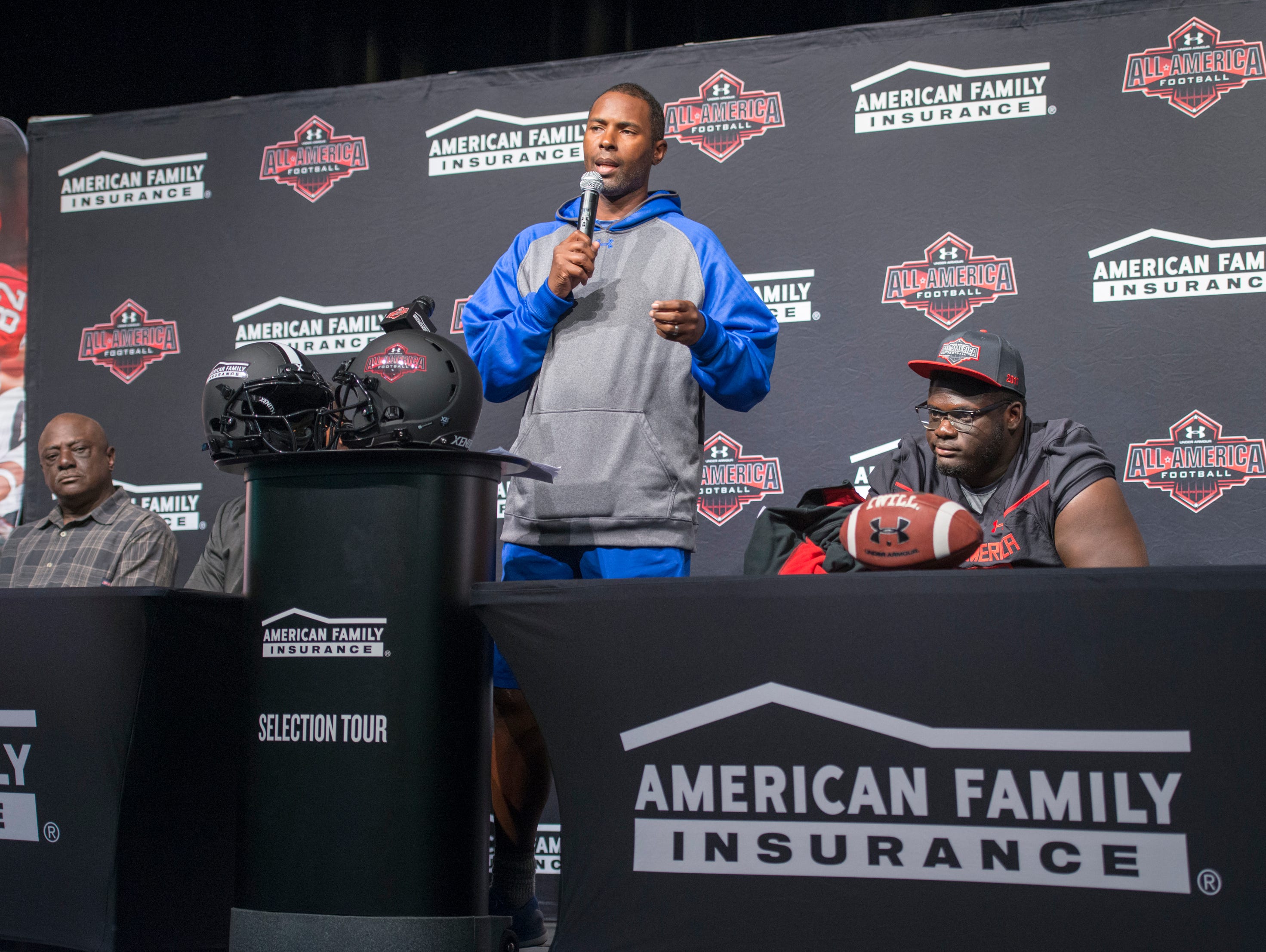 Coach Charlie Ward speaks during the event announcing that football player Alex Leatherwood, right, has been selected for the annual Under Armour High School All-America Game at Booker T. Washington High School in Pensacola on Wednesday, October 12, 2016. The game featuring more than 90 of the nation's best senior high school football players will be played on January 1, 2017.