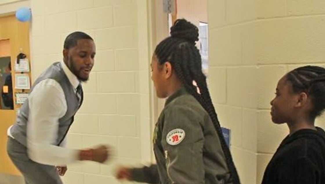 This N.C. teacher has a personalized handshake for every one of his students