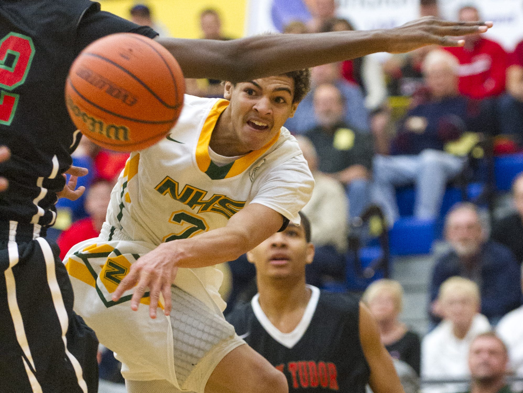 Northeastern High School sophomore Tyler Smith (2) fires off a pass after having his route to the basket blocked by Park Tudor High School sophomore Jaren Jackson, Jr. (32) during the first half of action. Greenfield-Central High School hosted the IHSAA Regional Boy's 2A Basketball tournament Saturday, March 14, 2015.