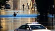 A kayaker paddles under the Shelby Street Bridge as