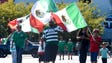 Mexican fans carry flags in support of their team at
