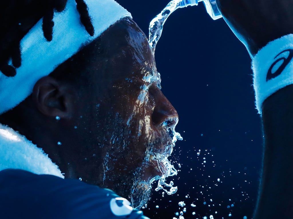 Gael Monfils of France attempts to cool down between games in his second round match against Novak Djokovic of Serbia on day four of the 2018 Australian Open at Melbourne Park in Melbourne, Australia.