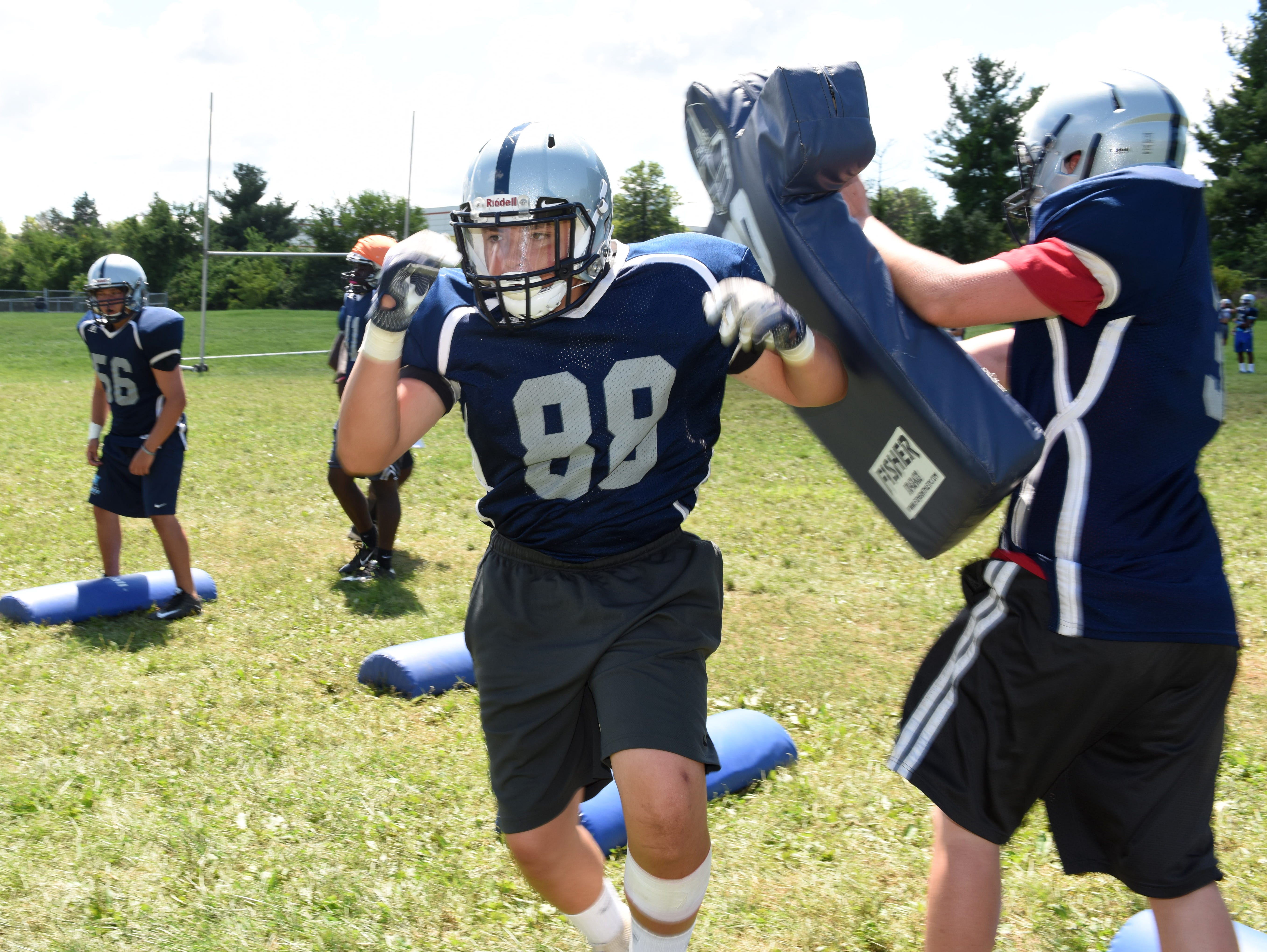 John Jay's from left, Luke Marchi hits Matt Egan during Thursday's preseason practice at John Jay High School.