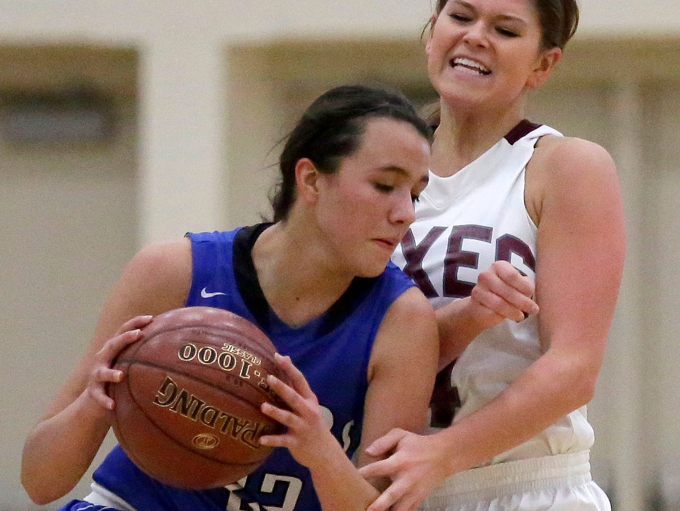 Whitney Henn of Fox Valley Lutheran defends against Kailee Van Zeeland of Wrightstown in a North Eastern Conference girls basketball game on Tuesday.