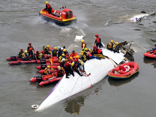 Search and rescue team members work on a TransAsia