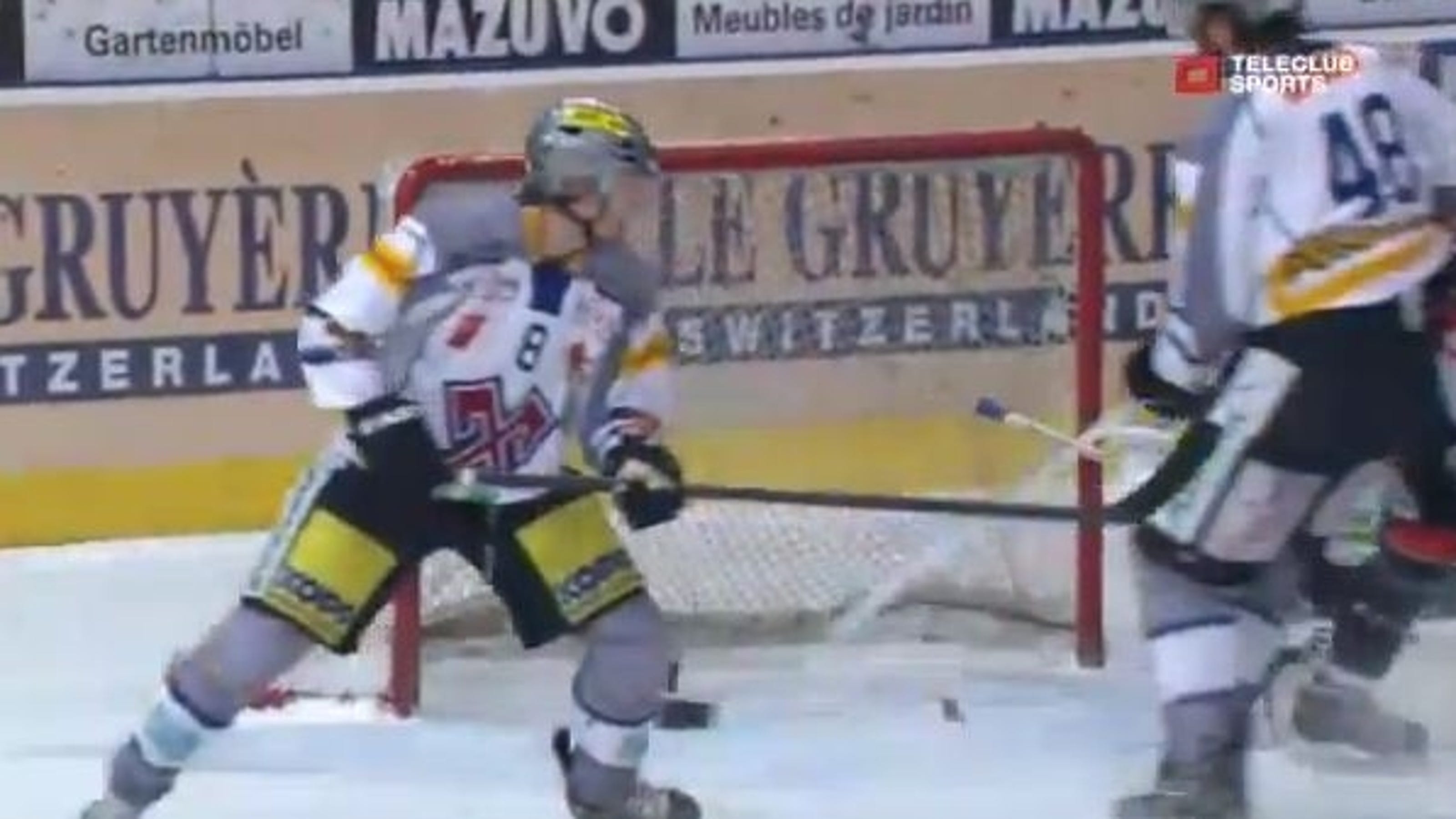 Hockey puck hits the post, splits in two pieces