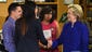 Clinton shakes hands with students after speaking at