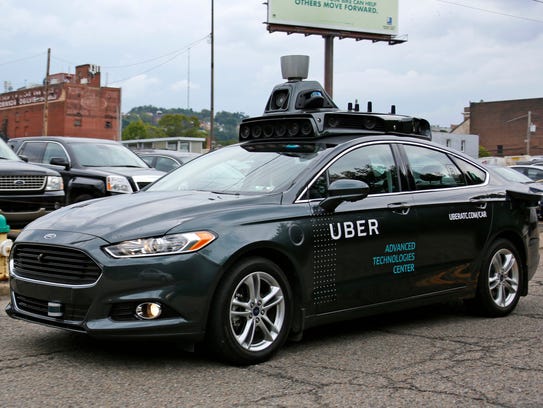 A self driving Uber car drives down River Road on Pittsburgh's