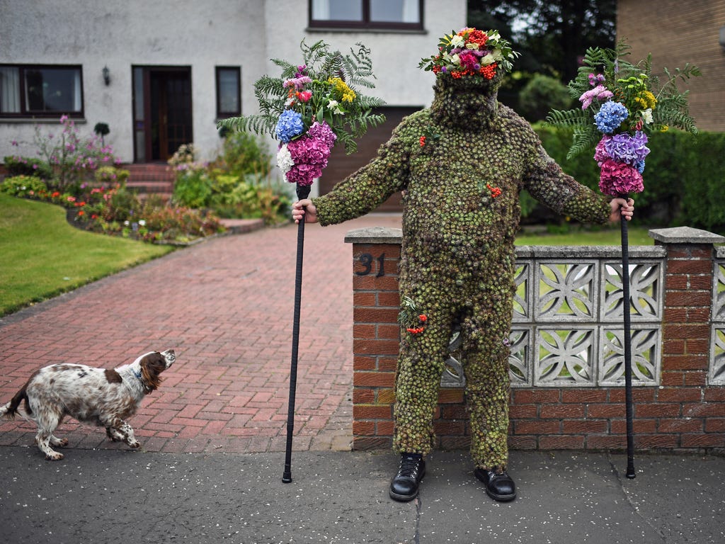 Burryman Andrew Taylor meets a resident as he parades through the town encased in burrs on Aug. 11, 2017 in South Queensferry, Scotland. The parade takes place on the second Friday of August each year and although the exact meaning of this tradition 